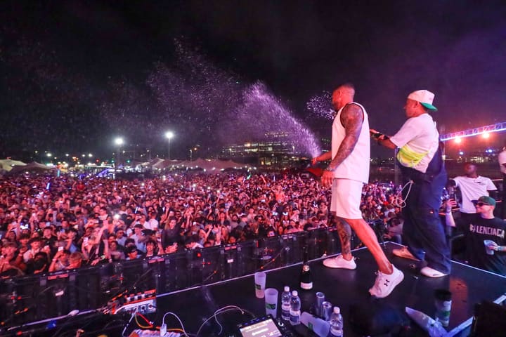 Champagne sprayed from the stage over a packed field at Secrets of Summer, midnight